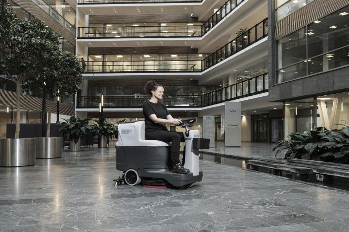 Ride-on floor scrubber cleaning the foyer of an administrative council building